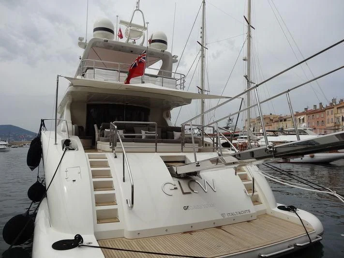 a boat docked at a pier aboard GLOW Yacht for Sale