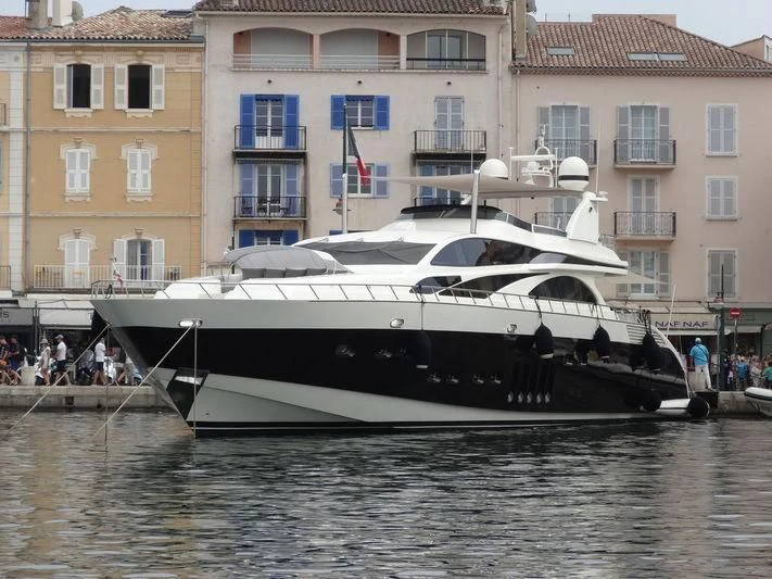 a boat docked in a canal aboard GLOW Yacht for Sale