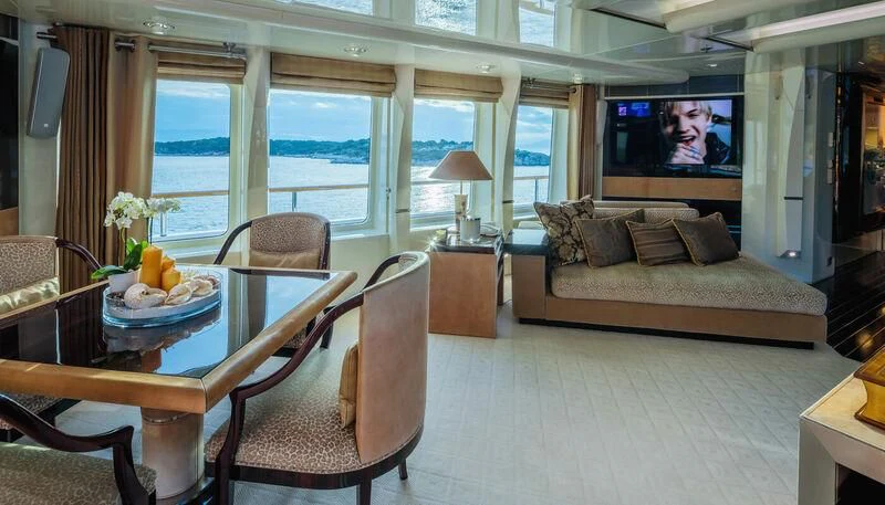a living room with a couch and a television aboard VERA Yacht for Sale