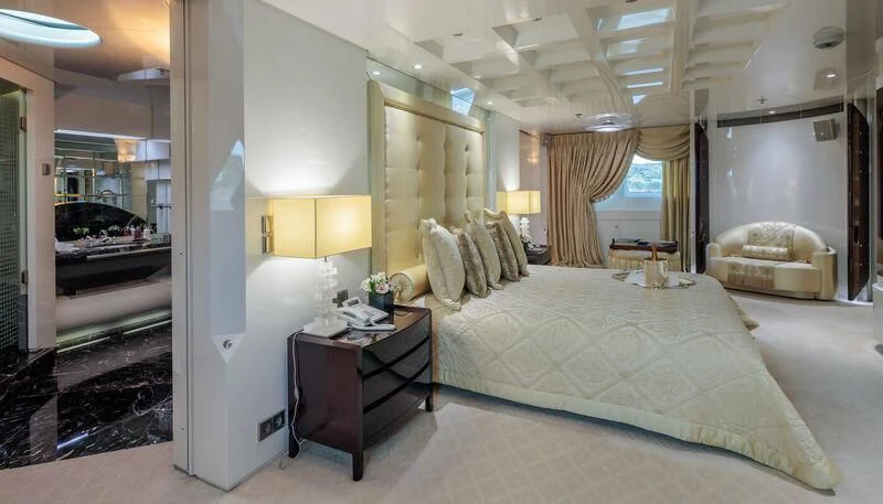 a bedroom with a bed and a desk aboard VERA Yacht for Sale