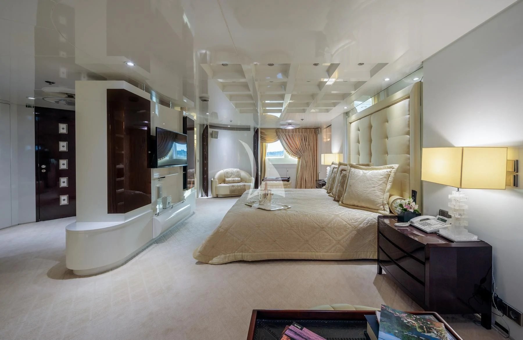 a bedroom with a bed and a desk aboard VERA Yacht for Sale