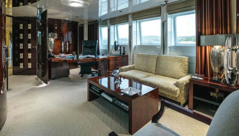 a living room with a couch and coffee table aboard VERA Yacht for Sale