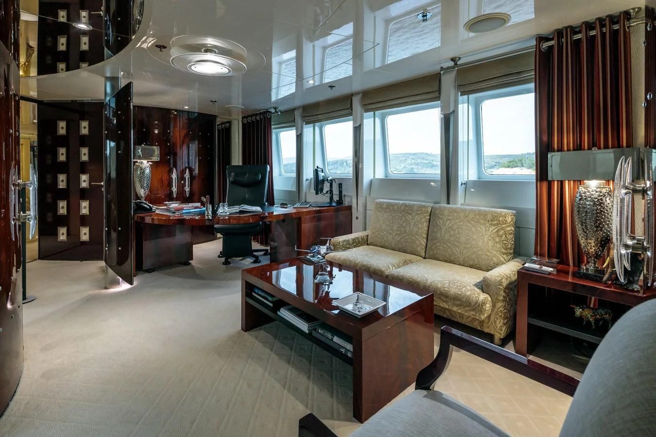a living room with a couch and coffee table aboard VERA Yacht for Sale