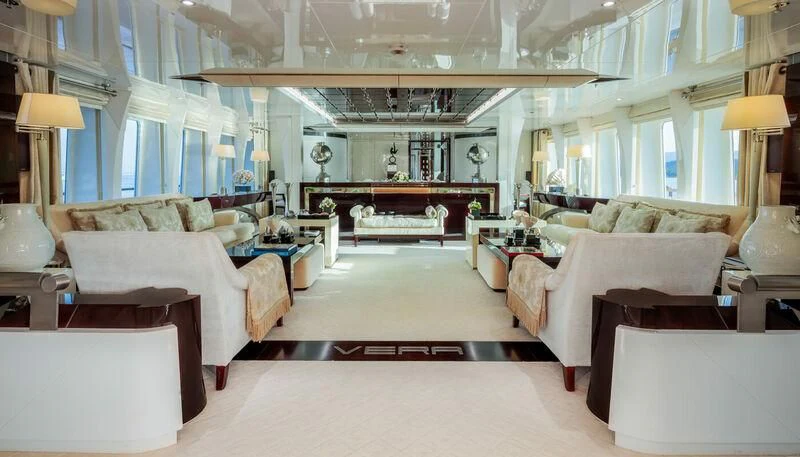 a large living room with white furniture aboard VERA Yacht for Sale