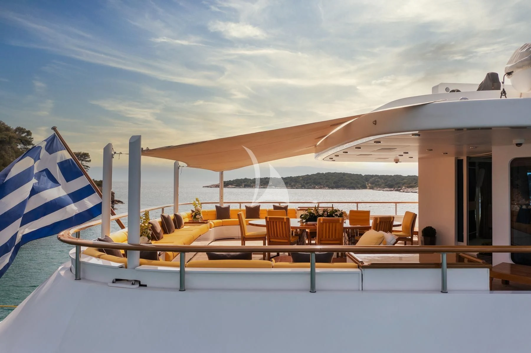 a large lounge area with a large lounge chair and umbrellas aboard VERA Yacht for Sale