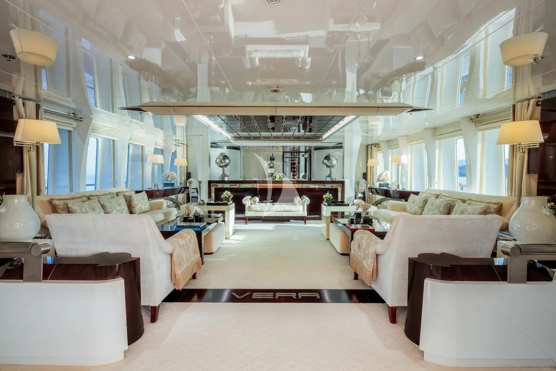 a large living room with white furniture aboard VERA Yacht for Sale