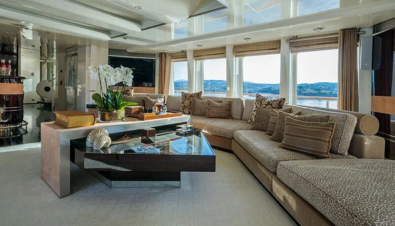 a living room with a couch and coffee table aboard VERA Yacht for Sale