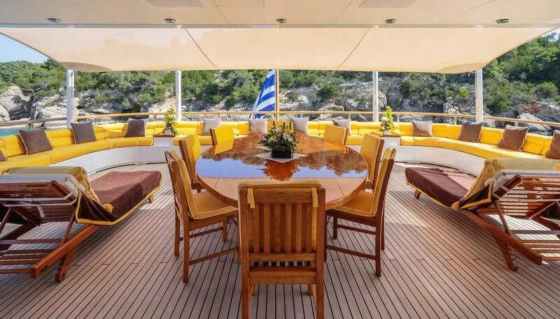 a room with tables and chairs aboard VERA Yacht for Sale
