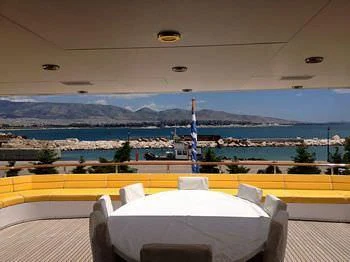 a large white chair on a balcony overlooking a city aboard VERA Yacht for Sale