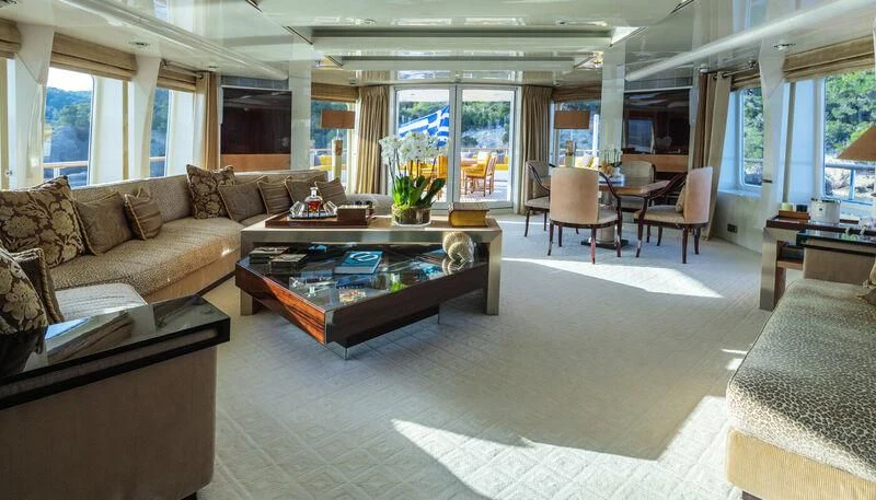 a living room with a couch and coffee table aboard VERA Yacht for Sale
