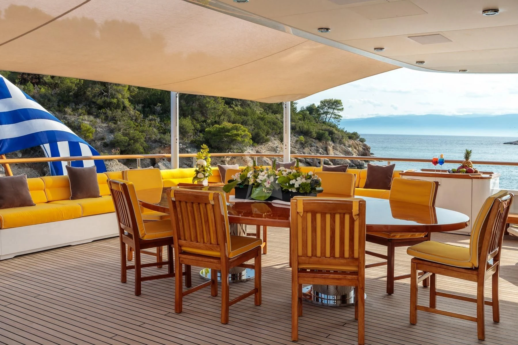 a table and chairs on a patio aboard VERA Yacht for Sale