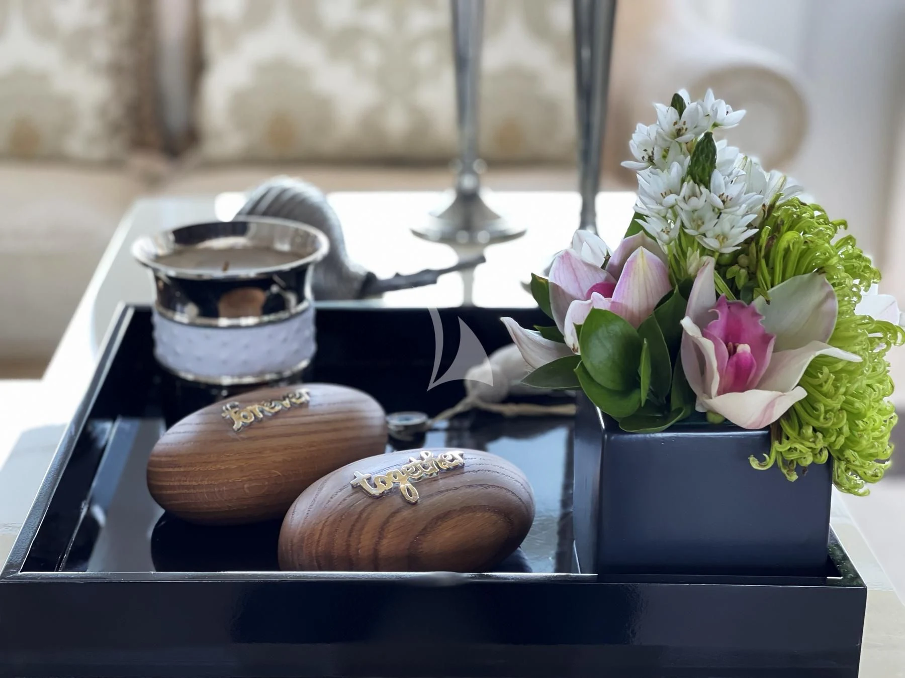 a table with a vase of flowers and a snail aboard VERA Yacht for Sale