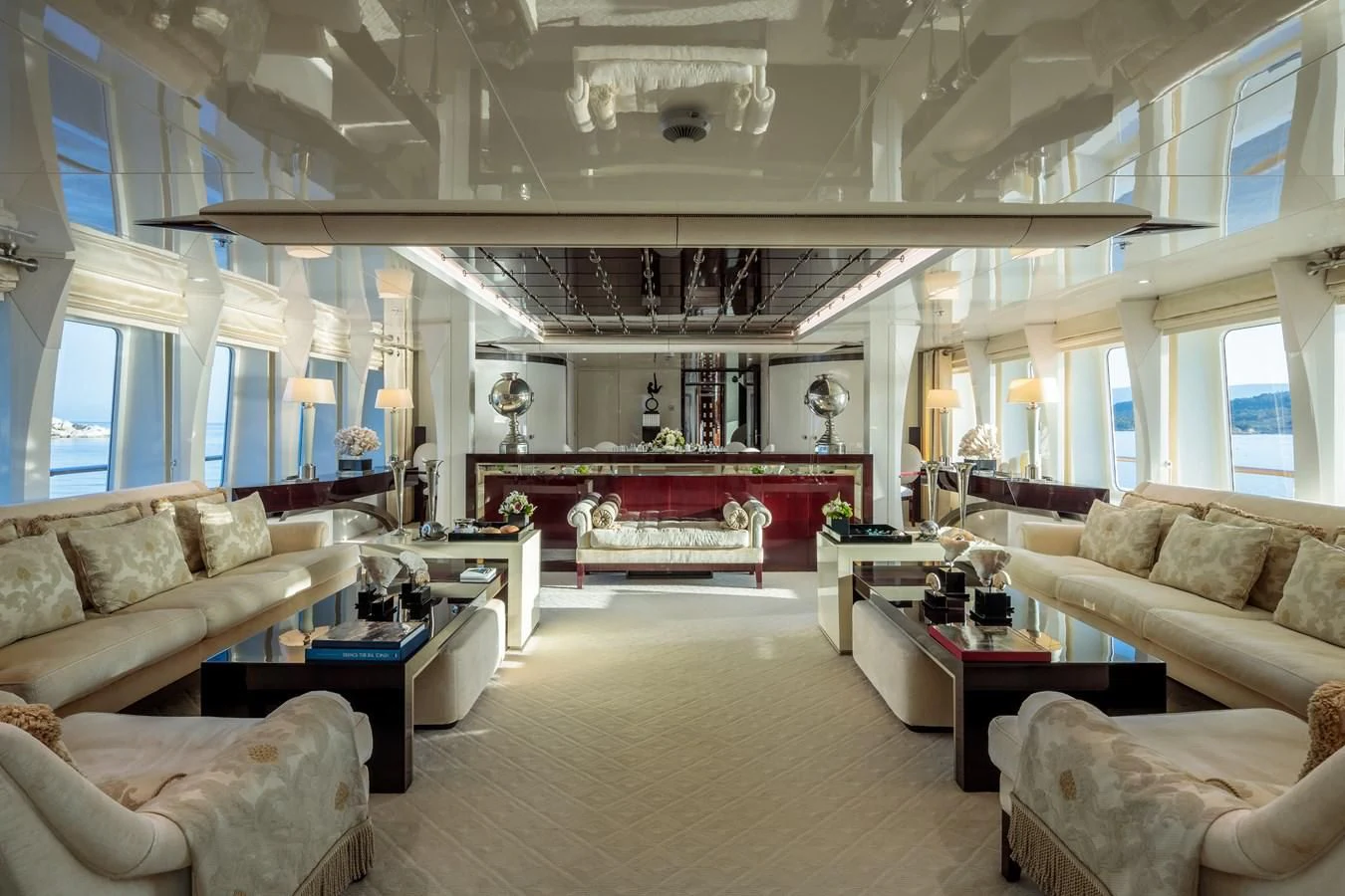 a living room with a large chandelier aboard VERA Yacht for Sale