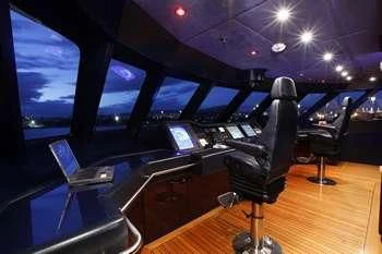 a room with a large table with chairs and computers on it aboard VERA Yacht for Sale