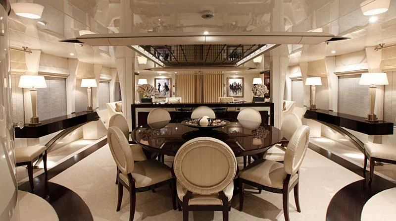 a large room with a table and chairs aboard VERA Yacht for Sale