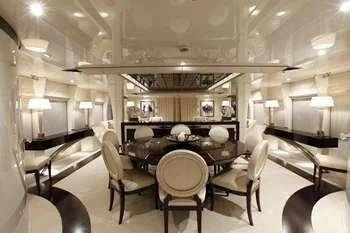 a room with a table chairs and a large mirror aboard VERA Yacht for Sale