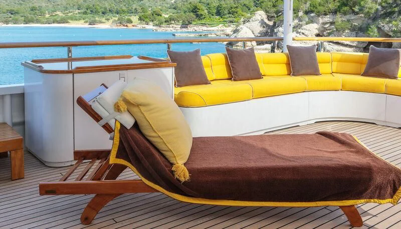 a bed with a colorful pillow aboard VERA Yacht for Sale