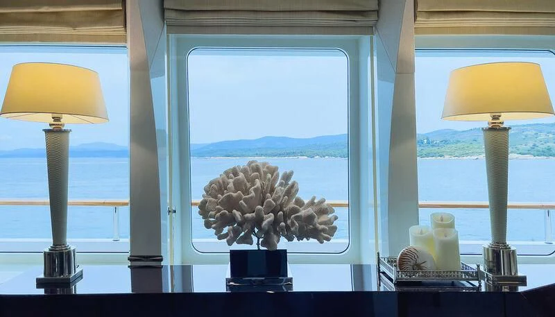 a window with a vase of flowers aboard VERA Yacht for Sale
