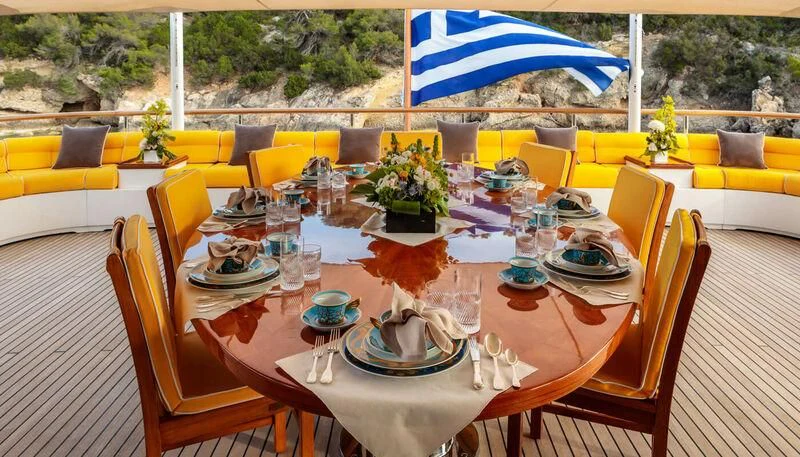 a table set for a dinner aboard VERA Yacht for Sale