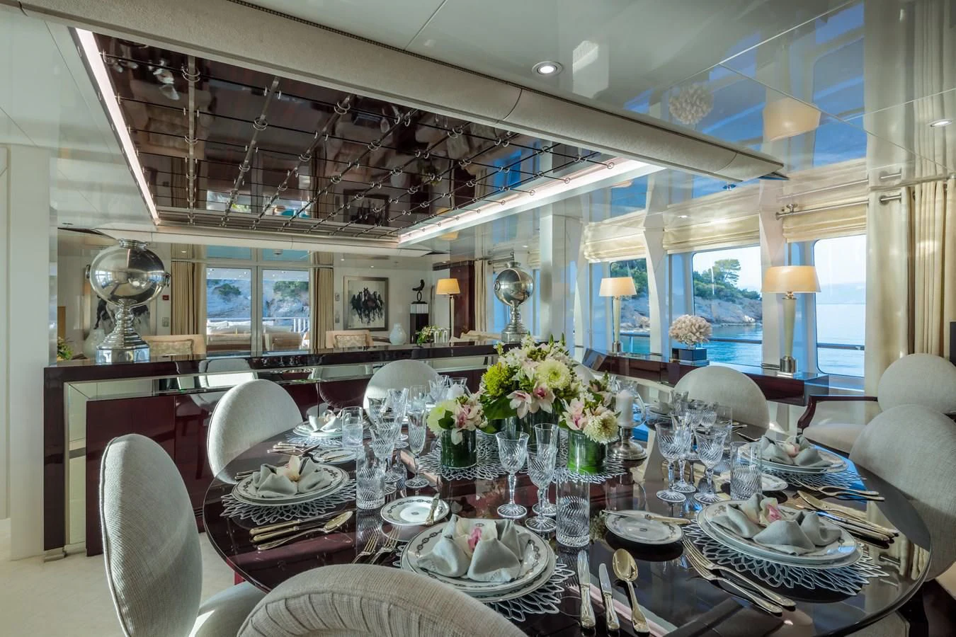 a large dining room with a large table set for a formal dinner aboard VERA Yacht for Sale