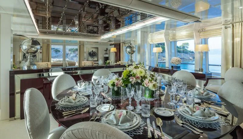a large dining room with a chandelier and chairs aboard VERA Yacht for Sale