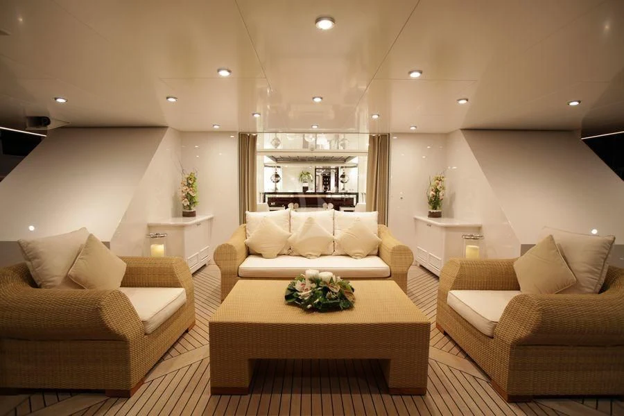 a living room with white furniture aboard VERA Yacht for Sale
