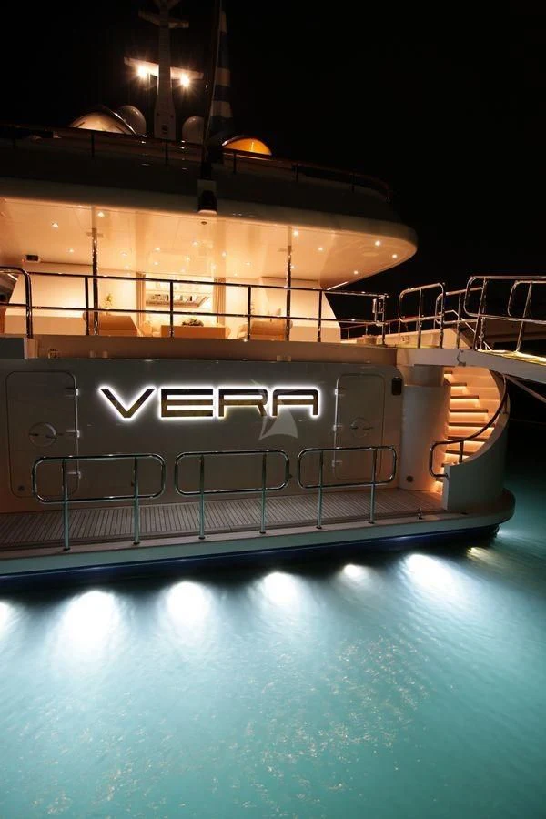 a swimming pool with a large building in the background aboard VERA Yacht for Sale