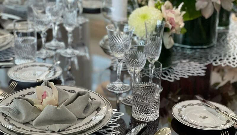 a table with empty glasses and plates aboard VERA Yacht for Sale