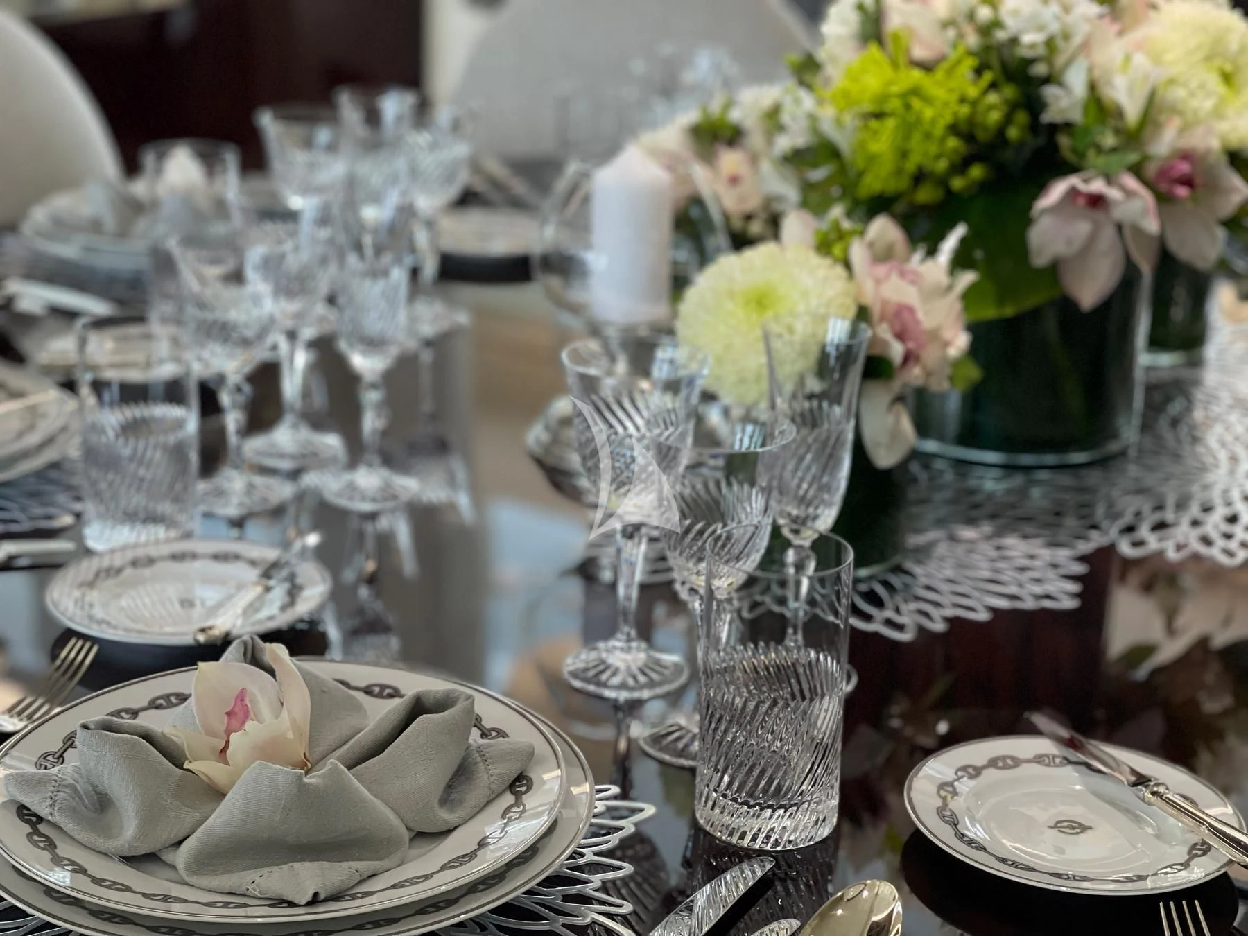 a table set with silverware and flowers aboard VERA Yacht for Sale