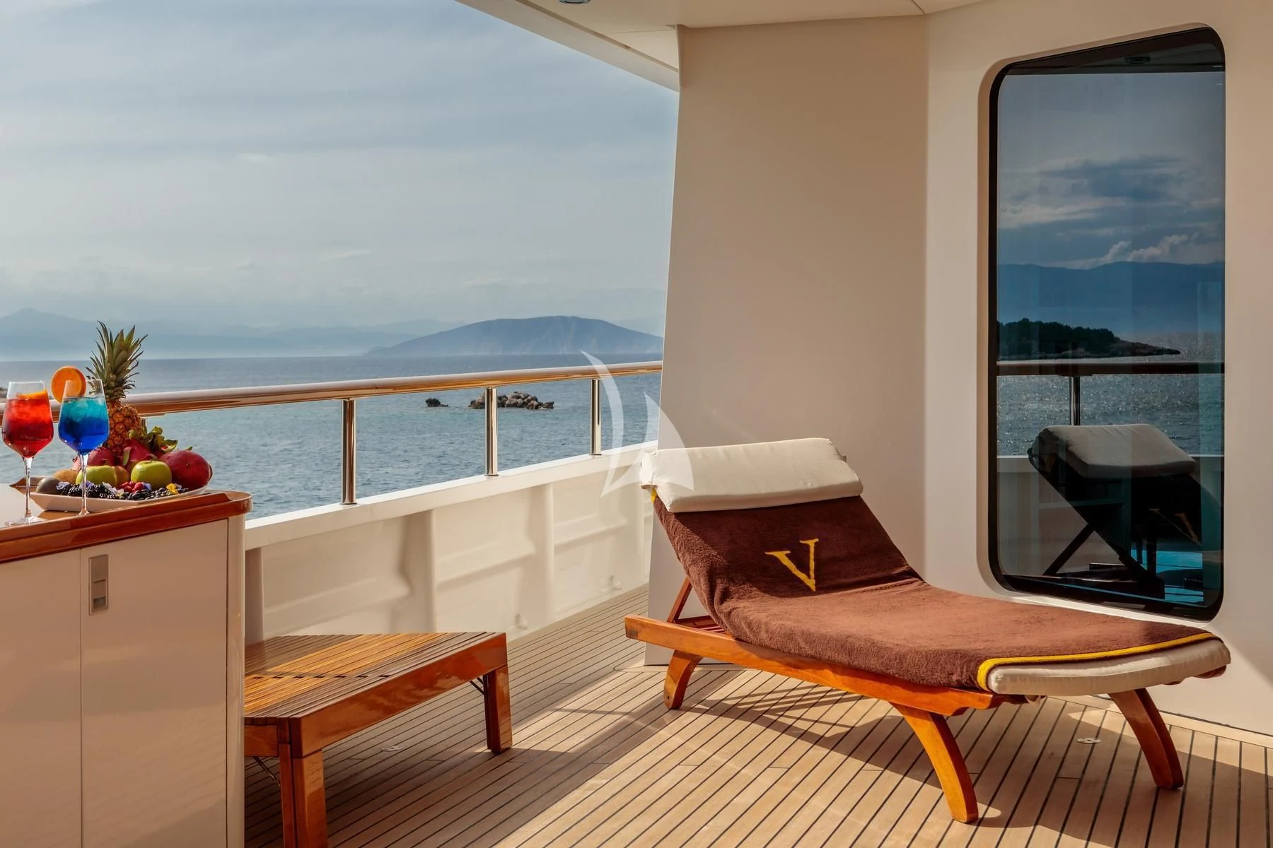 a room with a bed and a table and a window aboard VERA Yacht for Sale