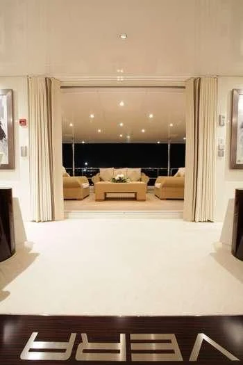 a living room with a large screen aboard VERA Yacht for Sale