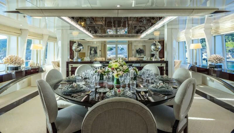 a dining room with a table and chairs aboard VERA Yacht for Sale