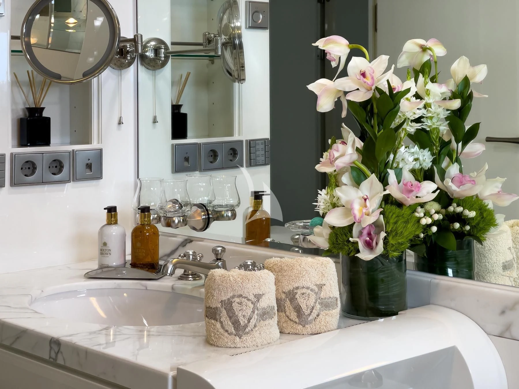 a bathroom sink with a flower vase aboard VERA Yacht for Sale