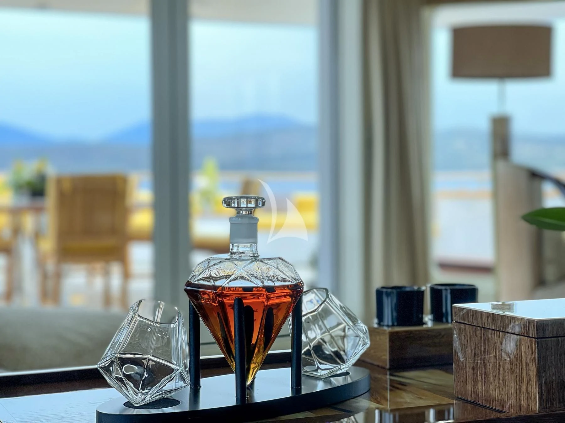 a glass of liquid on a table aboard VERA Yacht for Sale