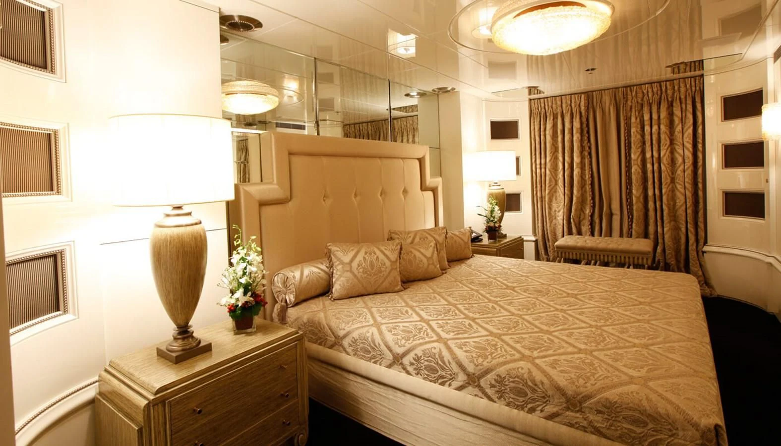 a bed with a lamp on it aboard VERA Yacht for Sale