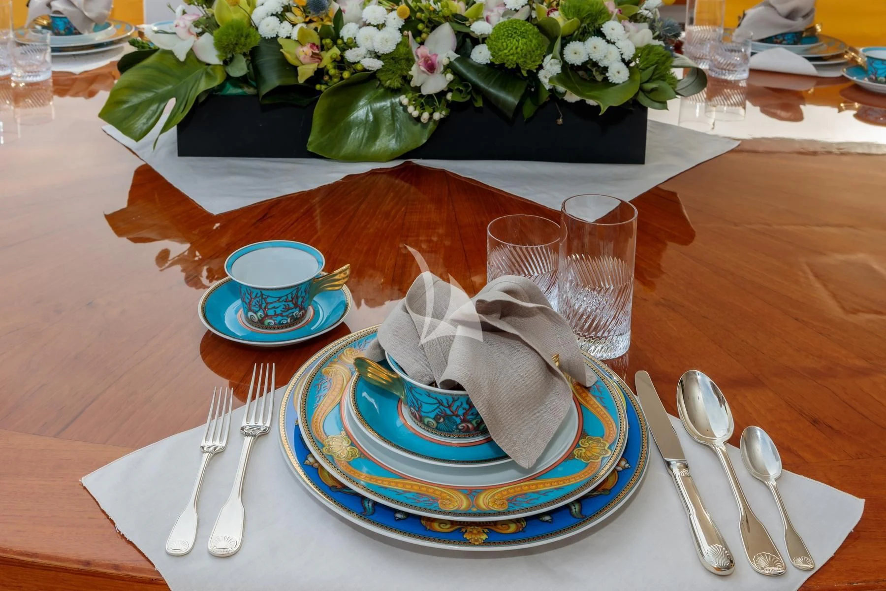 a plate of food and silverware on a table aboard VERA Yacht for Sale