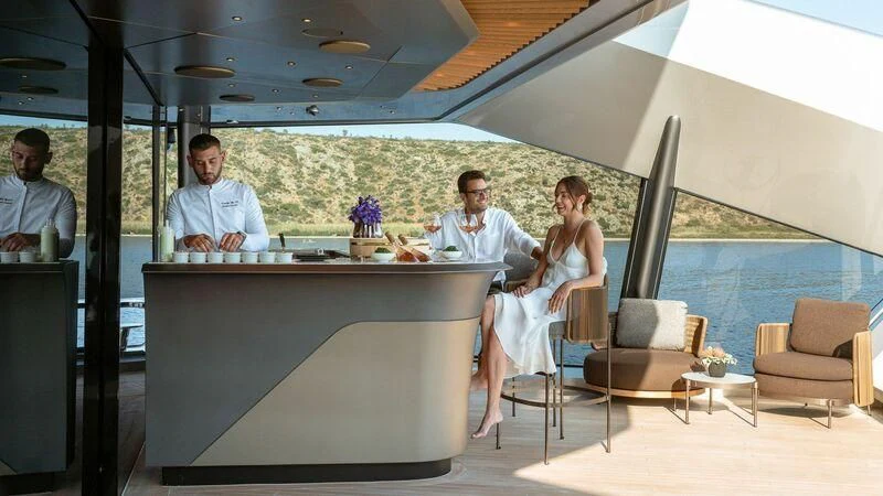 a group of people sitting at a table aboard THIS IS IT I Yacht for Sale