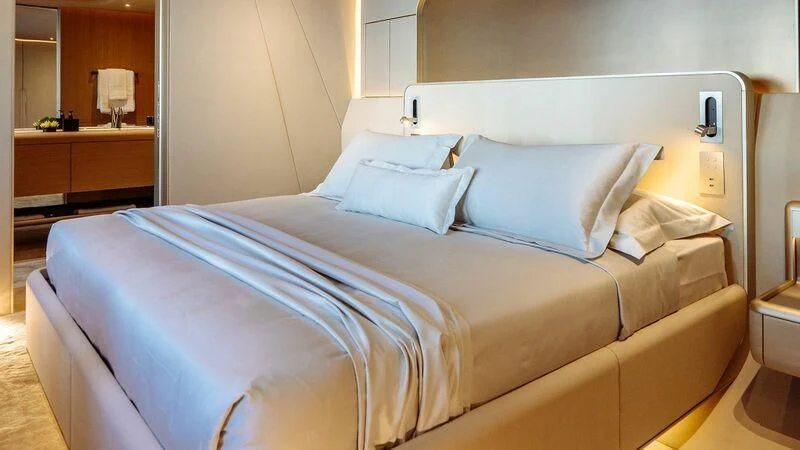 a bed with white sheets aboard THIS IS IT I Yacht for Sale