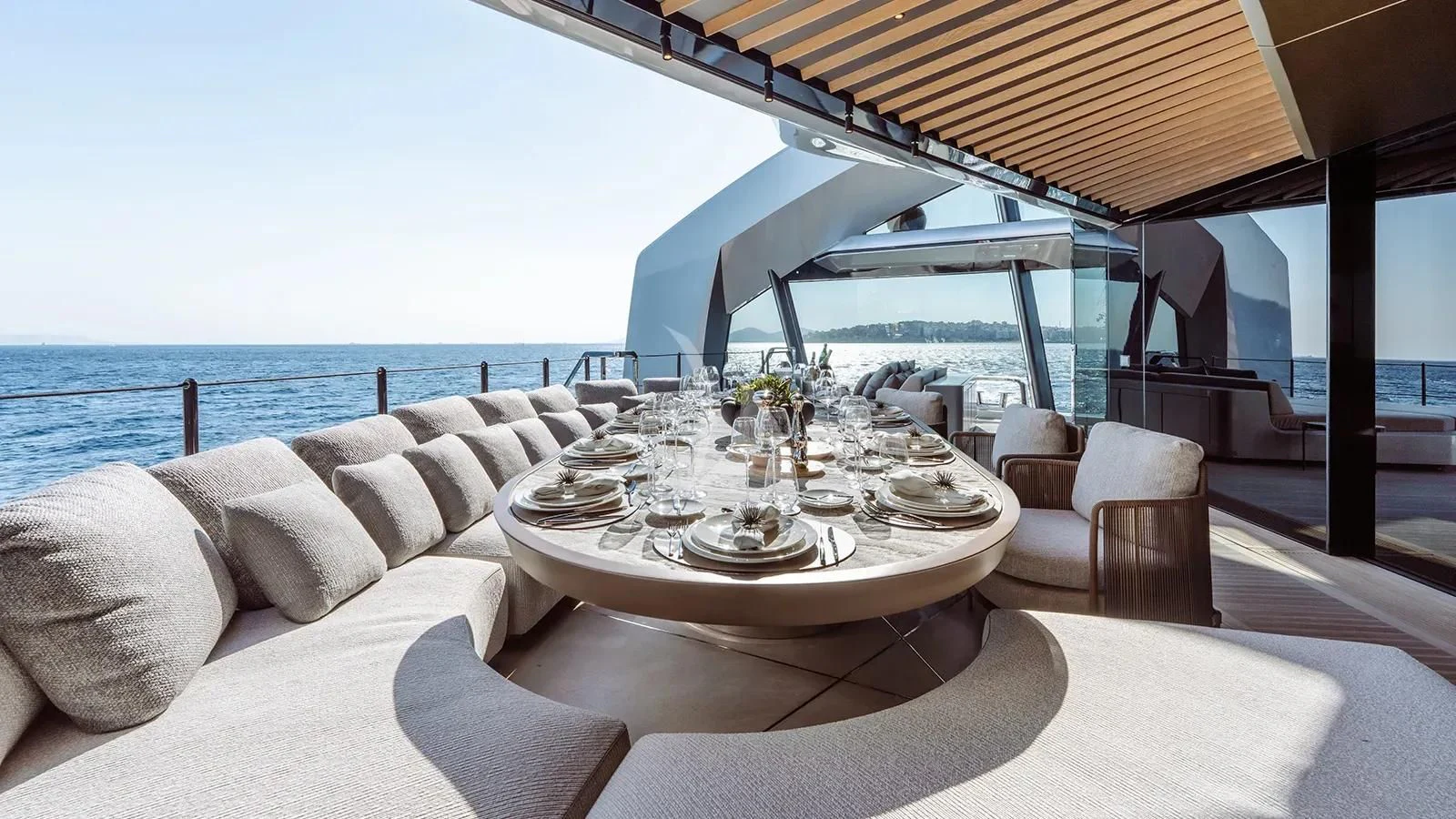 a table set for a meal on a balcony overlooking the ocean aboard THIS IS IT I Yacht for Sale