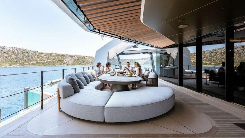 a group of people sitting around a table on a boat aboard THIS IS IT I Yacht for Sale