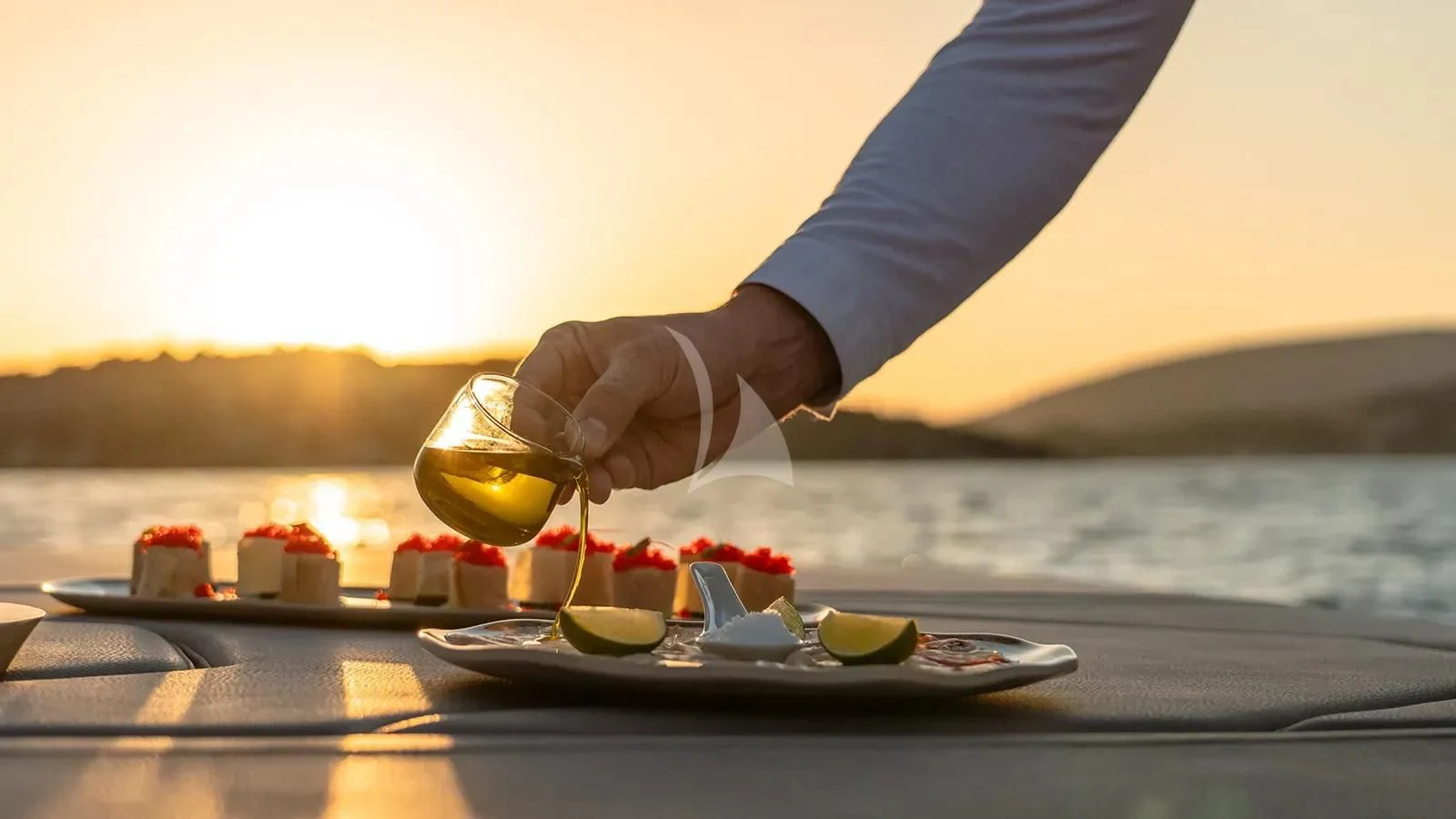 a person pouring a liquid into a glass aboard THIS IS IT I Yacht for Sale