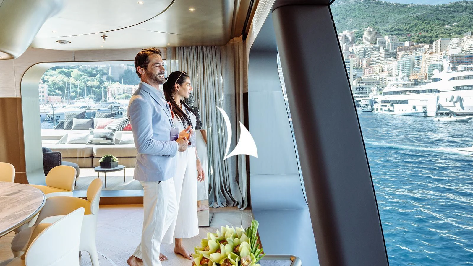 a man and woman kissing on a balcony overlooking a city aboard THIS IS IT I Yacht for Sale