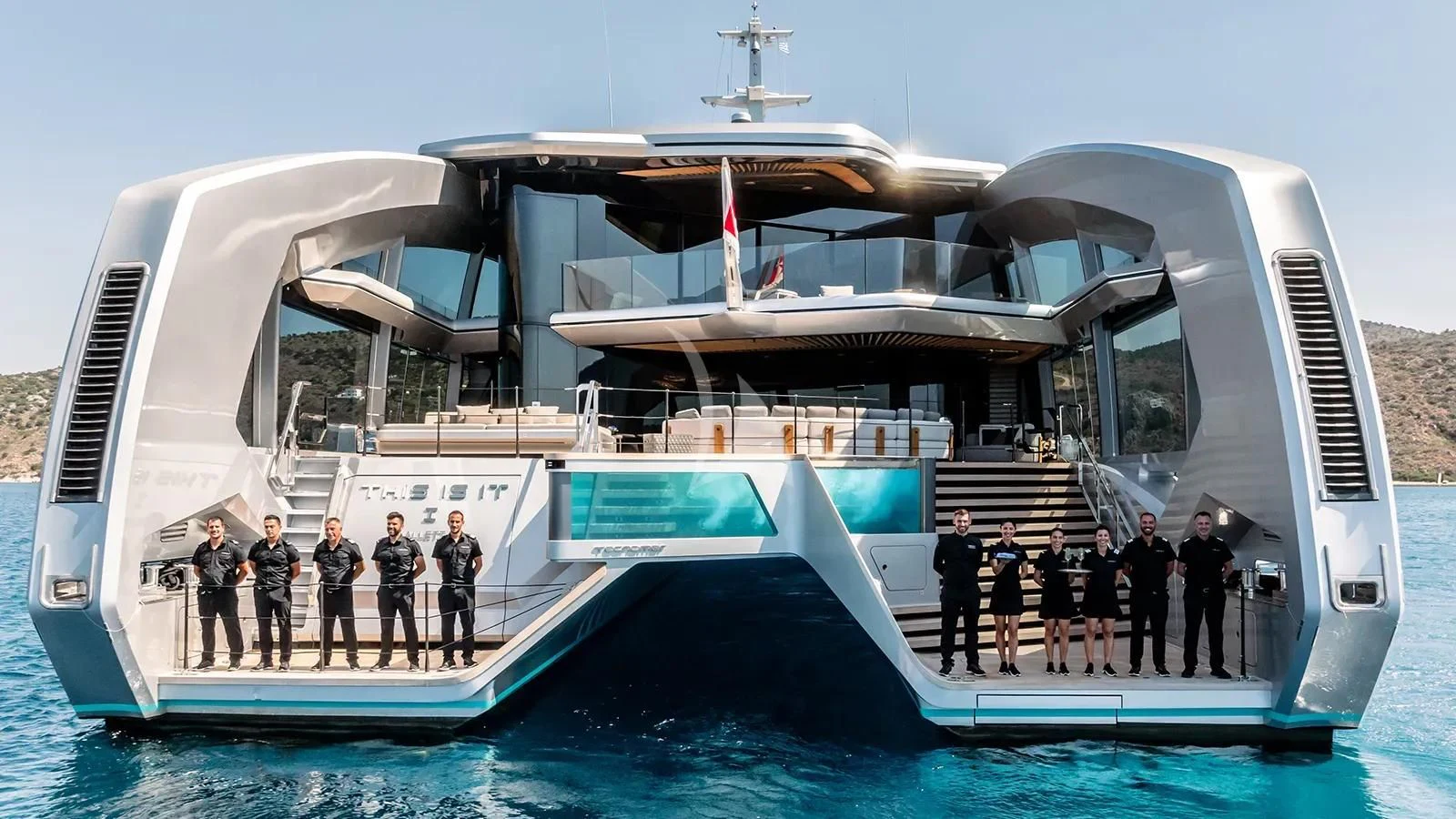 a group of people standing on a boat in the water aboard THIS IS IT I Yacht for Sale
