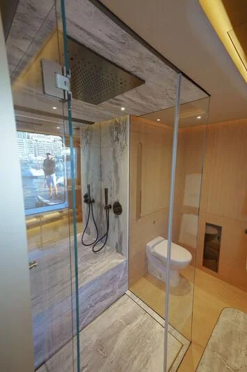 a bathroom with a glass shower aboard THIS IS IT I Yacht for Sale