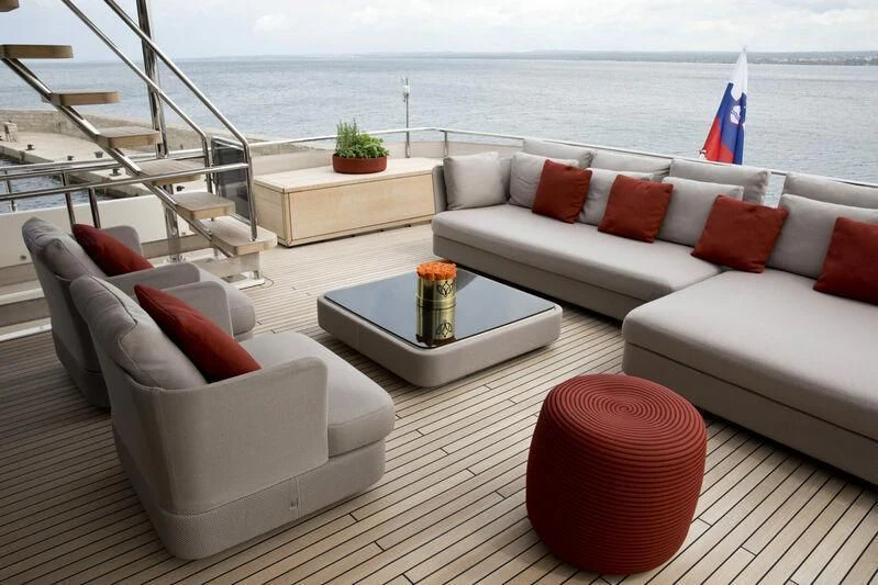 a living room with a couch and a table with a flag on it aboard CHELONIA Yacht for Sale