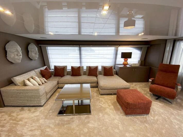 a living room with a large couch aboard CHELONIA Yacht for Sale