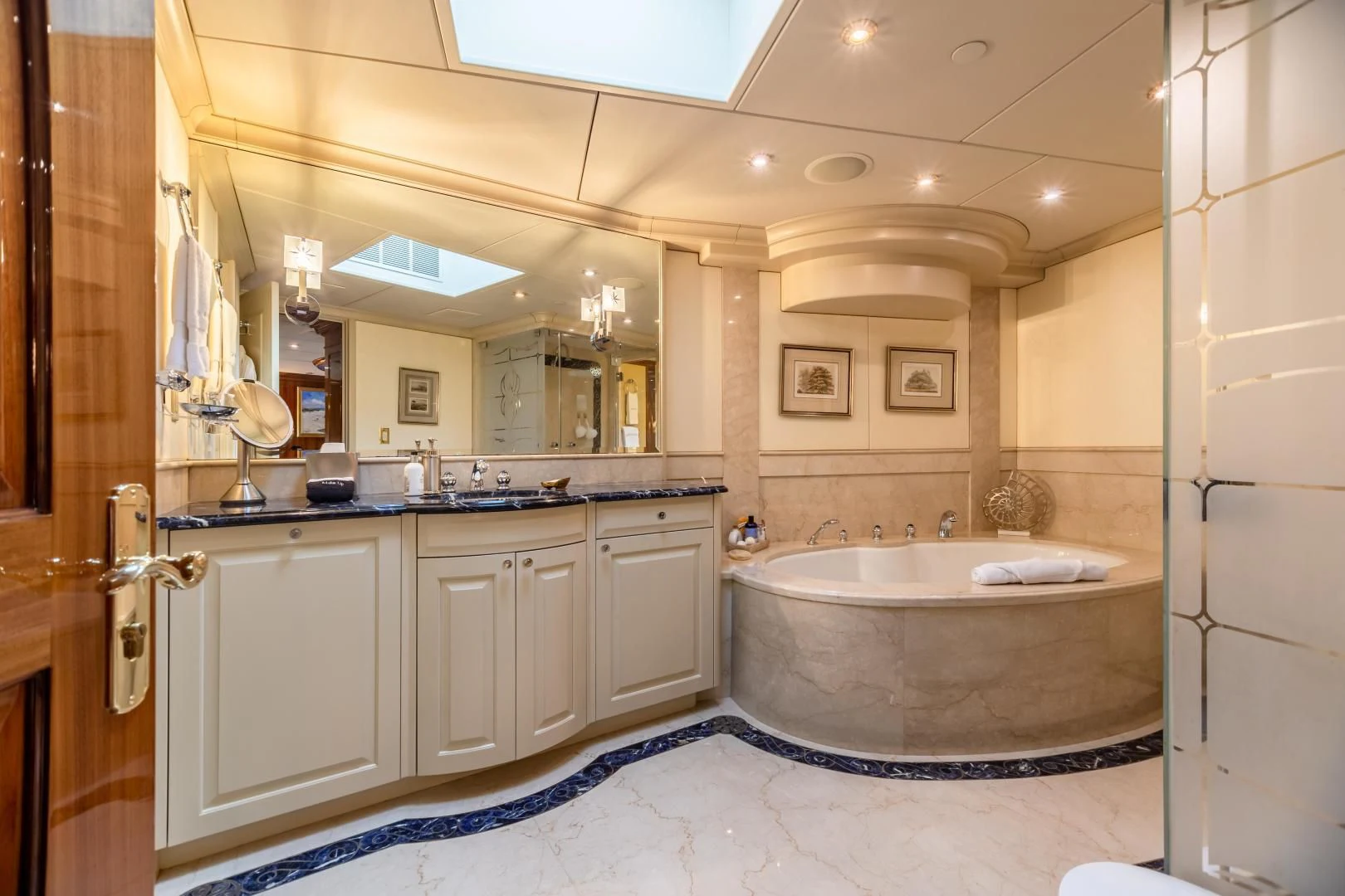 a bathroom with a tub sink and cabinets aboard AMORE Yacht for Charter