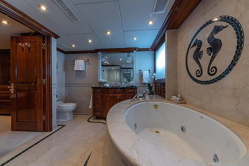 a bathroom with a bathtub and toilet aboard AMORE Yacht for Charter