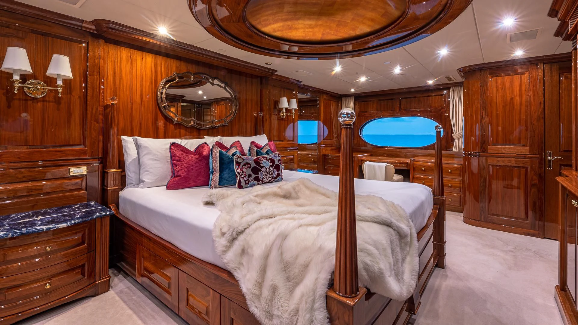 a bedroom with a bed and a mirror aboard AMORE Yacht for Charter