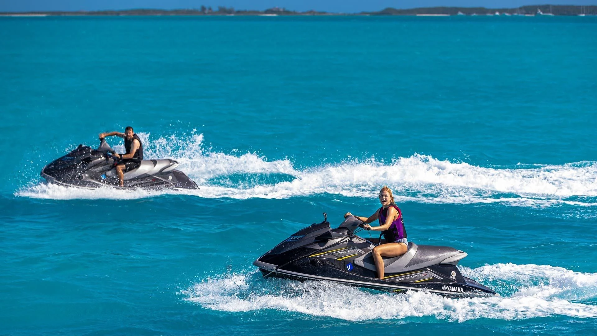 a couple of people on a jet ski in the water aboard AMORE Yacht for Charter